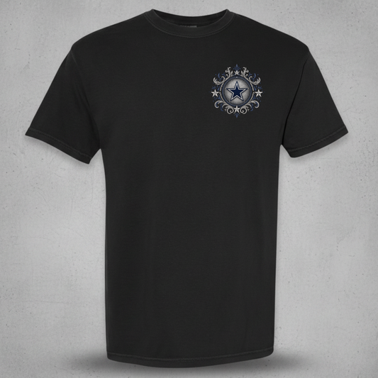 A black short-sleeve crewneck t-shirt with a small circular graphic on the left chest featuring a blue star and silver decorative elements, displayed against a textured gray background.
