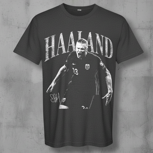 A dark gray graphic t-shirt featuring a black and white print of footballer Sven Haaland with the name 'HAALAND' printed above him, displayed against a textured gray concrete wall.