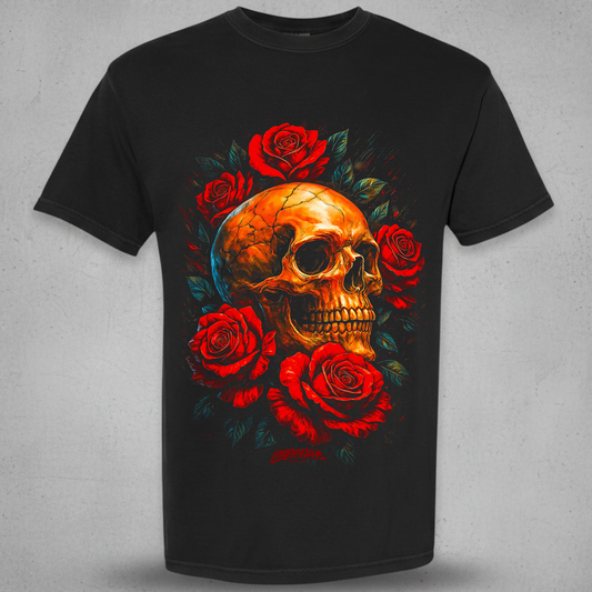 A black short-sleeve crewneck t-shirt featuring a large graphic print of a golden skull surrounded by red roses and dark green leaves, displayed against a textured gray background.