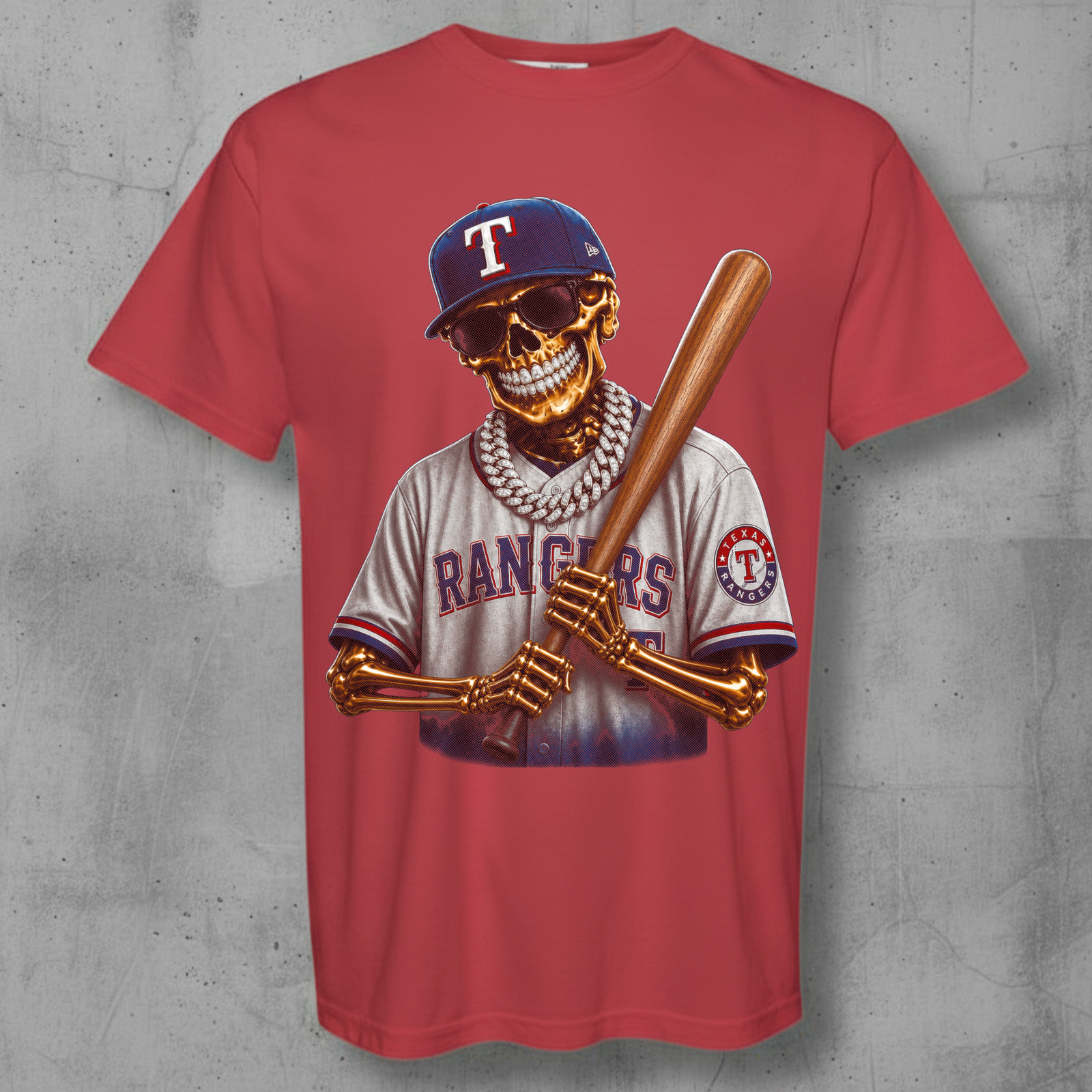 A red short-sleeve crewneck t-shirt featuring a detailed graphic of a skeleton baseball player wearing a Texas Rangers jersey and holding a bat, displayed against a textured gray concrete background.