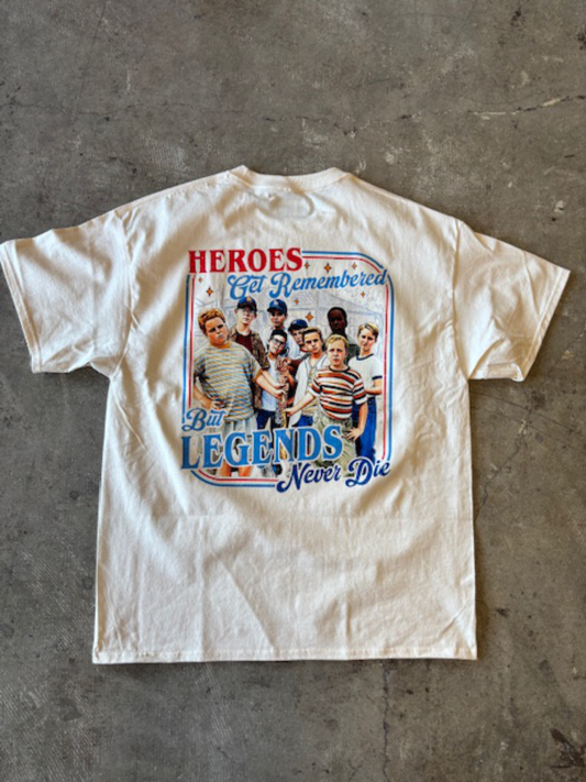 White t-shirt with Sandlot graphic design on a gray concrete surface