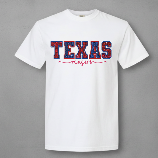White t-shirt with he words Texas in a red and blue shinny glitter 