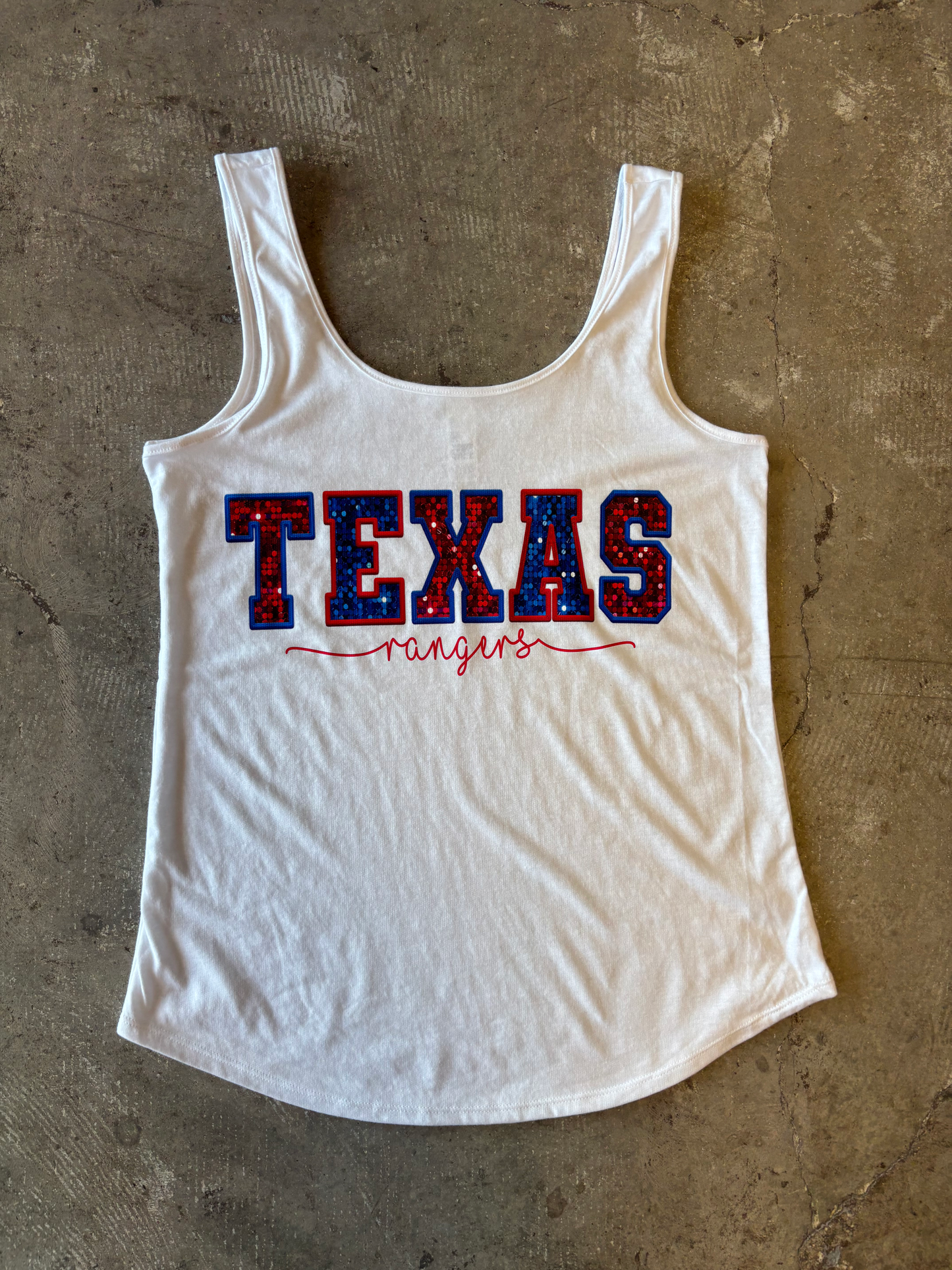 White tank top with 'TEXAS rangers' text on a concrete surface