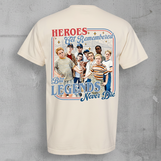 Beige t-shirt with Sandlot design on a gray concrete background